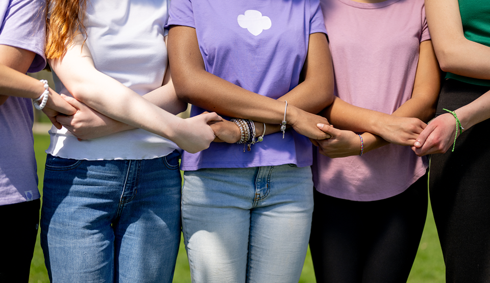 five older girls holding hands
